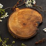 top-view-empty-desk-wooden-along-with-white-flowers-dark-background